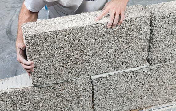 Hempcrete block being handled for sustainable construction