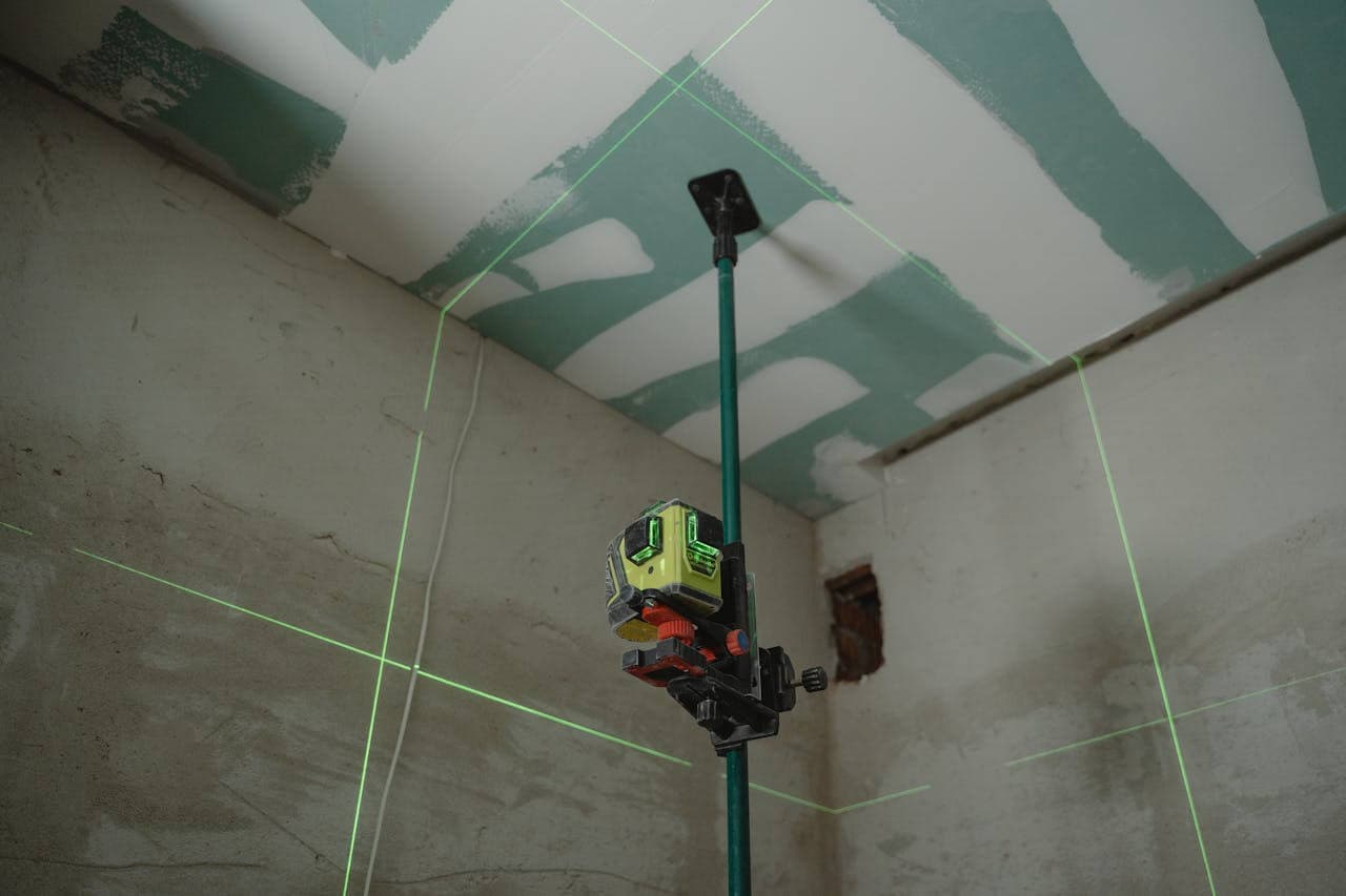 Low-VOC paint application with laser level guidance